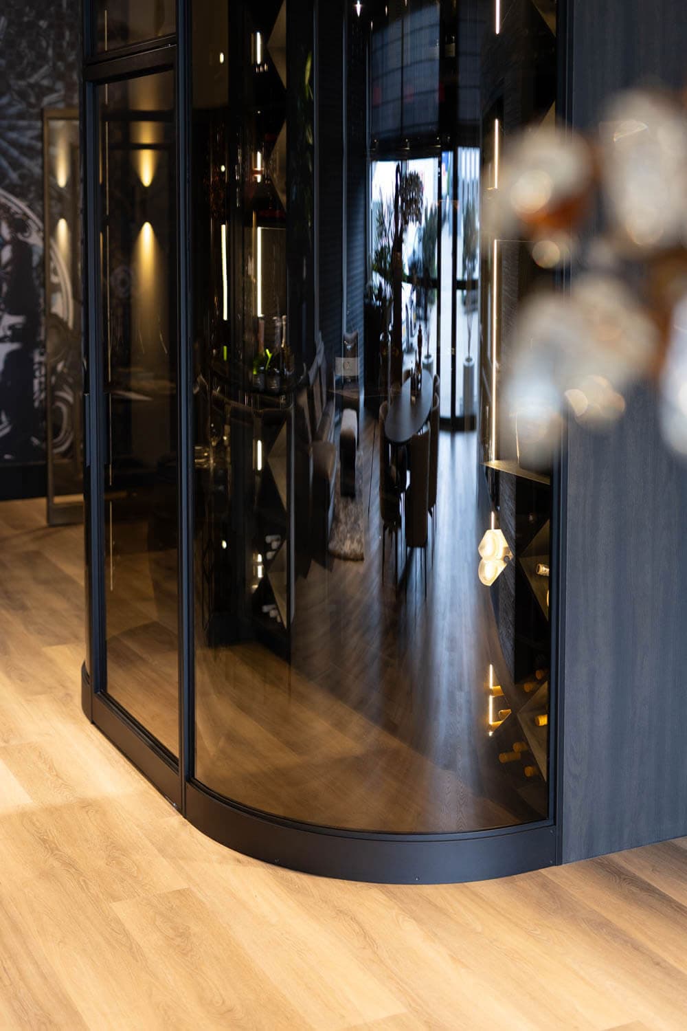 a curved steel screen used in a wine room