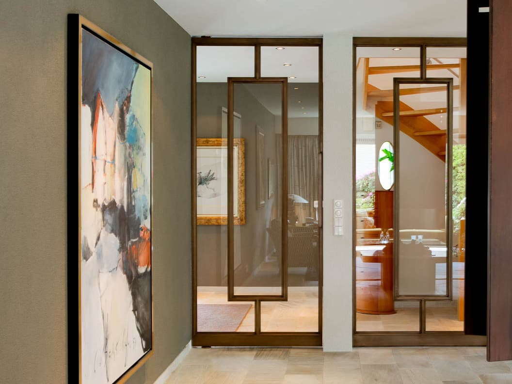 pivoting steel glazed door design in bronze finish