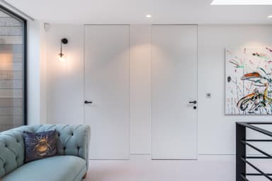 2 hidden jib doors that are flush to a white wall