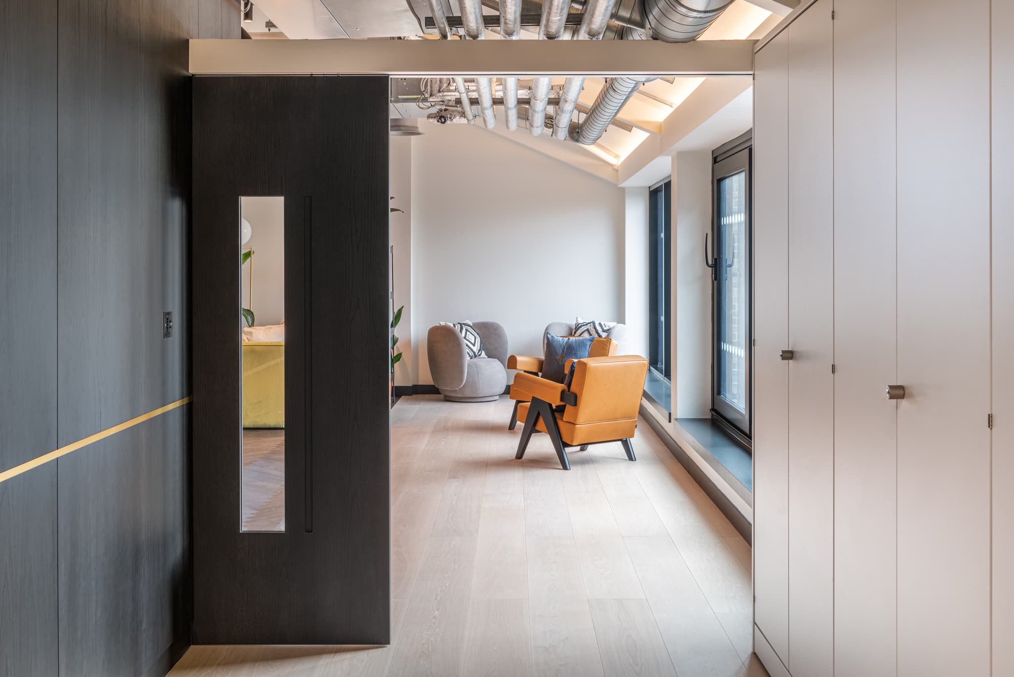 A semi closed sliding pocket door in a contemporary office environment.