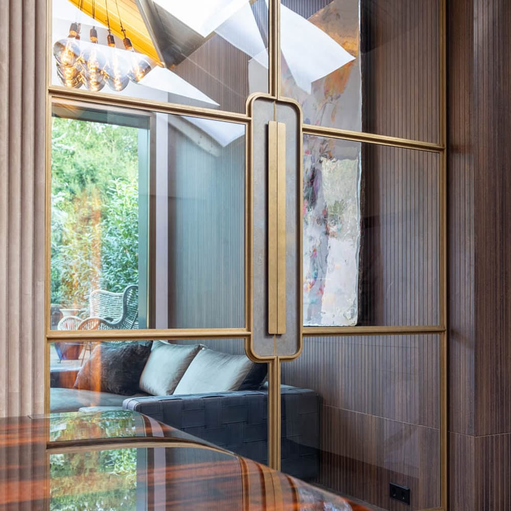 an interior steel glazed door with leather backplate to handle