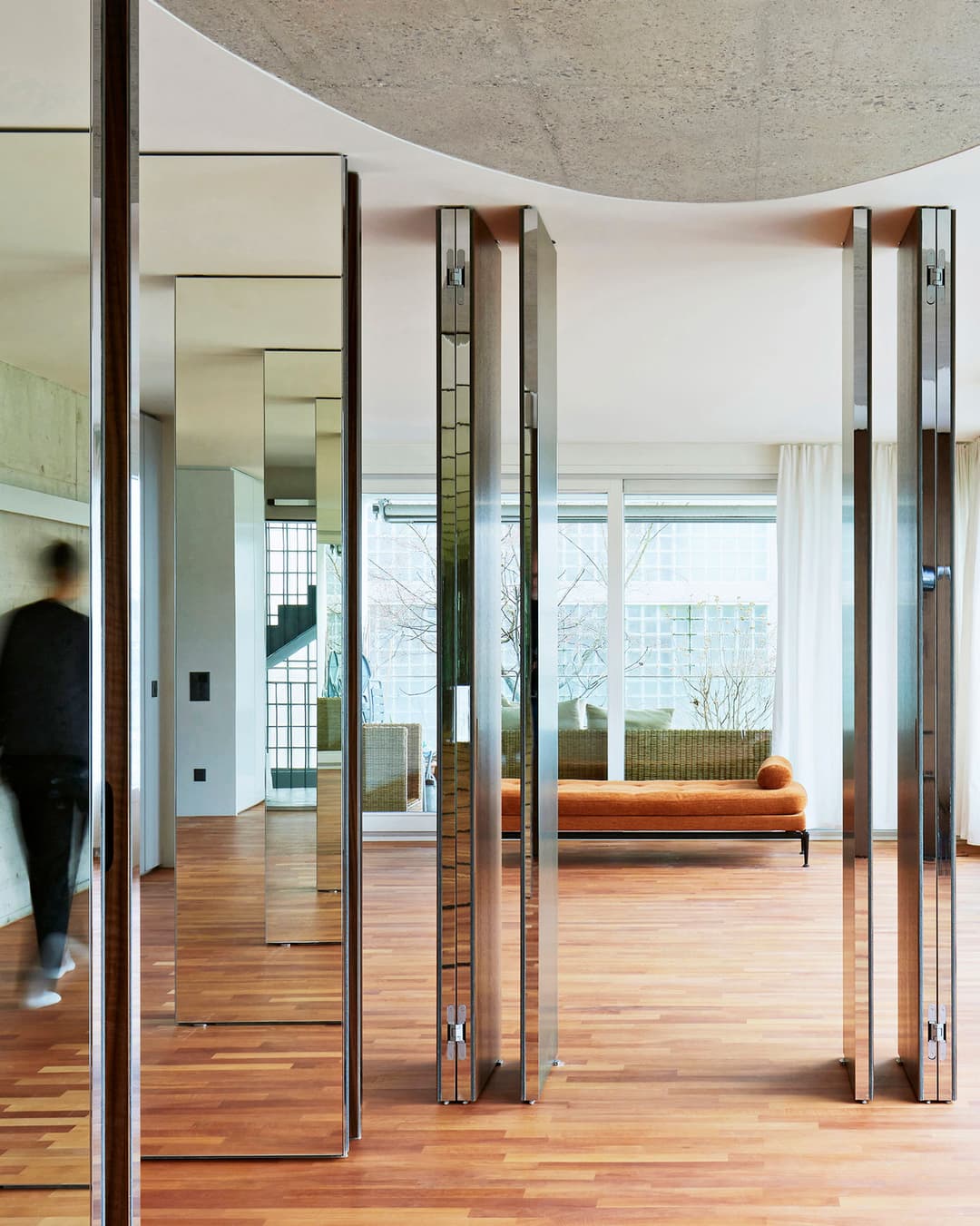 pivot doors with mirror cladding create a room within a room